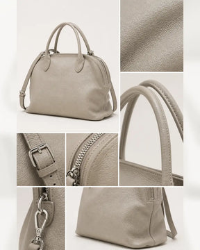 Detalhes da bolsa feminina de couro cinza claro Vivienne, mostrando textura, alças, fivela, zíper e mosquetão