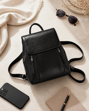 Mochila feminina de couro preta Corinne em composição com acessórios, destacando espaço interno e uso no dia a dia.