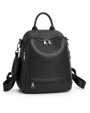 Mochila feminina de couro preta Serelle em vista frontal, com alça de mão, bolsos externos com zíper e detalhe lateral removível.
